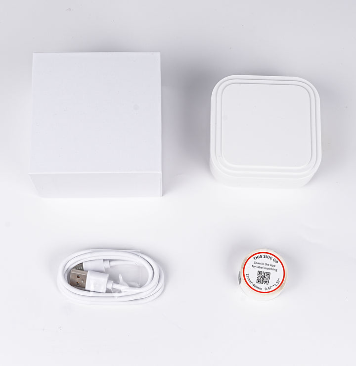 D32 white thermal label printer with USB cable, roll of labels, and packaging included