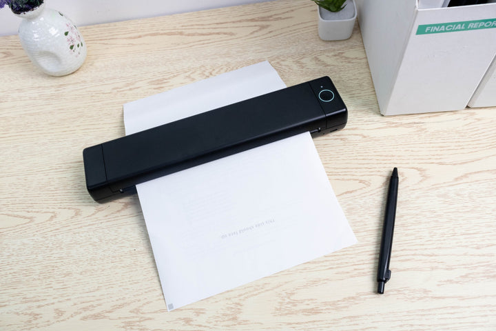 Dabbous Mega Supplies aimo Bluetooth A4 thermal printer printing on white paper on wooden desk
